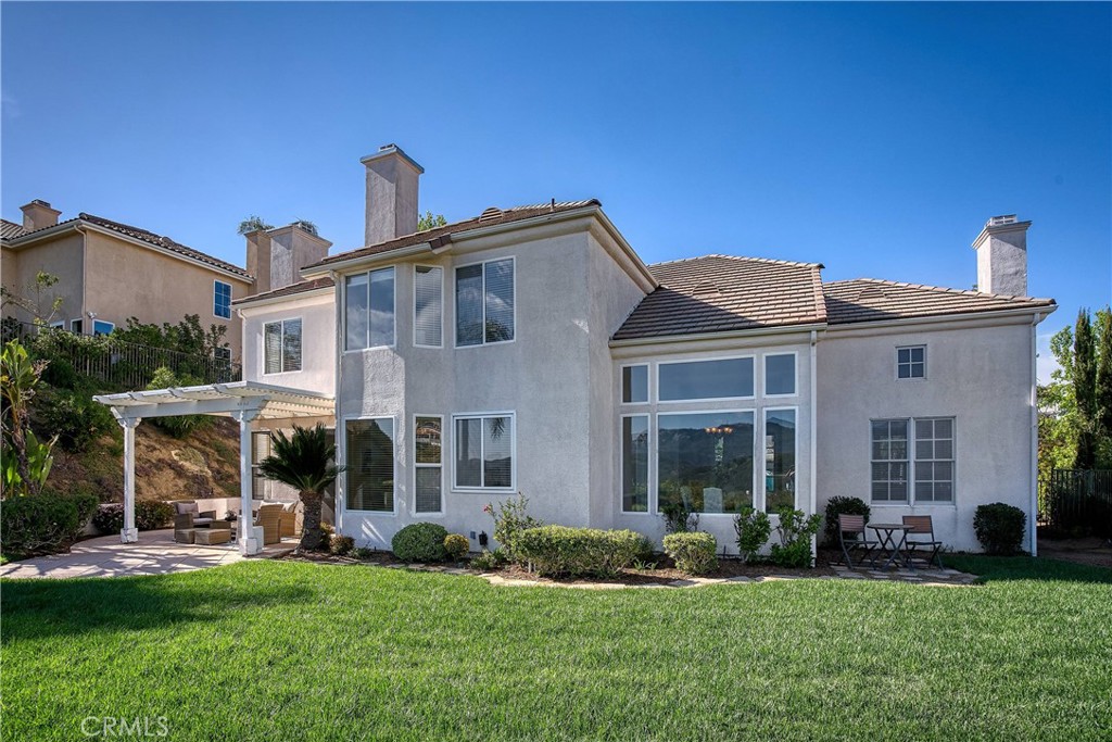 24932 Normans Way Calabasas, CA 91302 - Photo 59 of 63 a front view of a house with a garden
