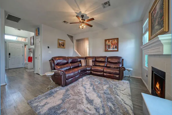 a living room with furniture and a fireplace