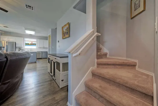 a view of entryway and hall with wooden floor
