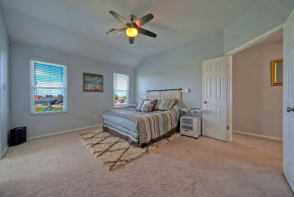 a bedroom with a bed and painting on the wall