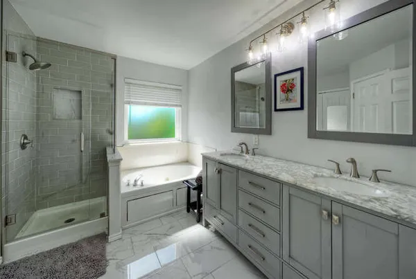 a bathroom with a granite countertop sink mirror and shower