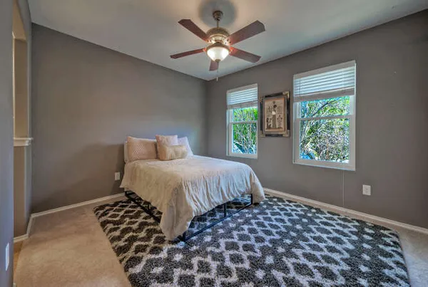 a bedroom with a large bed and a window