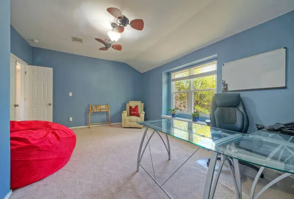 a bedroom with furniture and a large window