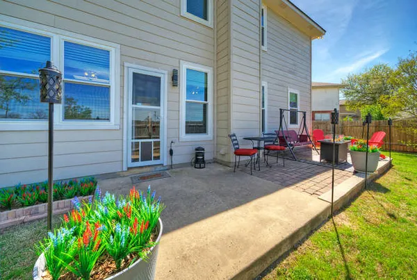 a view of a house with backyard and sitting area