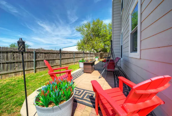 a view of a chairs and table in patio