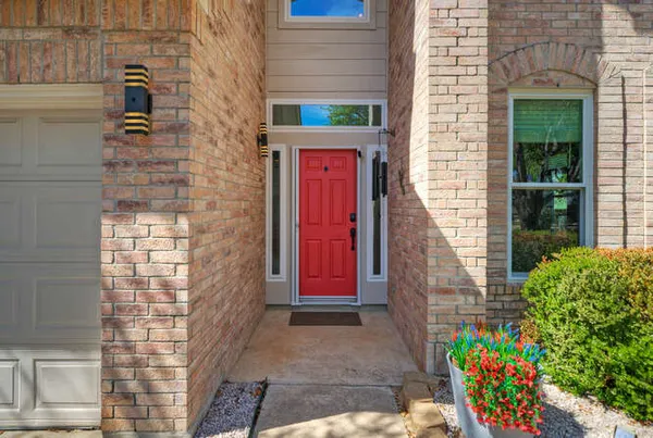 a view of a door of the house with a street