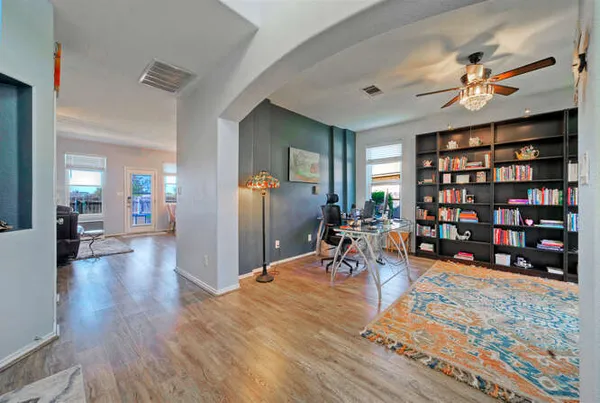 a view of a work space with furniture and wooden floor