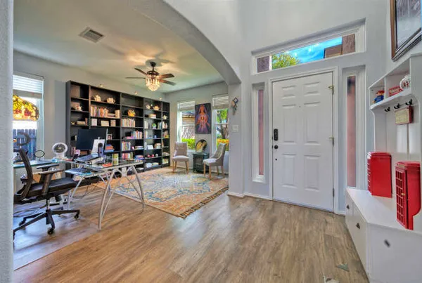 a view of a livingroom with workspace and a window