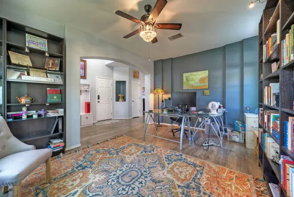 a living room with furniture and a book shelf