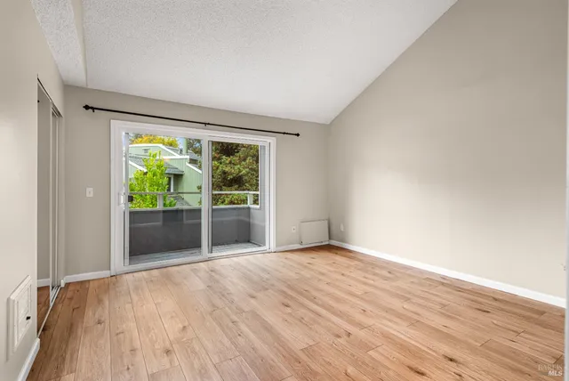 wooden floor in an empty room with a window