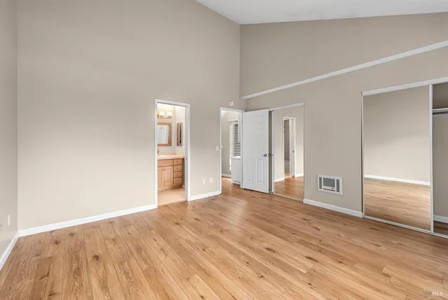 a bathroom with a toilet a sink a tub and a mirror