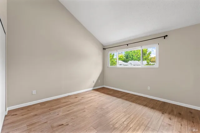 a view of a room with wooden floor
