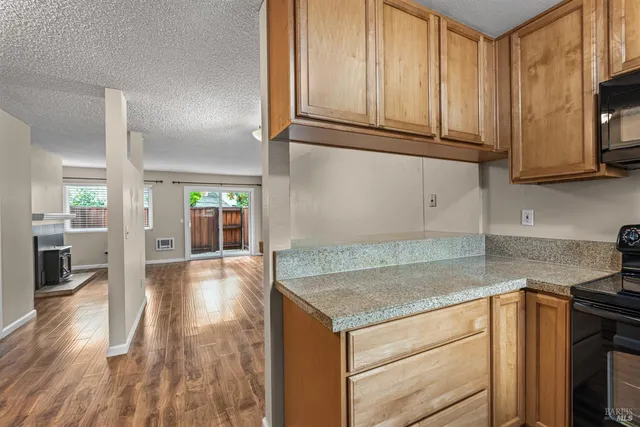 a kitchen with granite countertop cabinets stainless steel appliances and a counter space