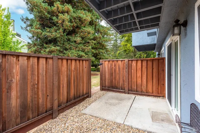 a swimming pool with table and chairs under an umbrella