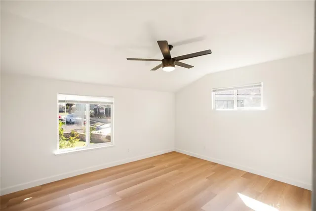 a view of a big room with wooden floor and a ceiling fan