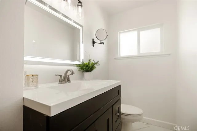 a view of a big room with wooden floor and windows