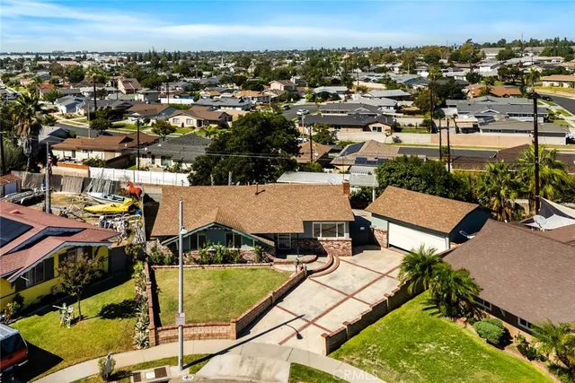 an aerial view of a house with a swimming pool