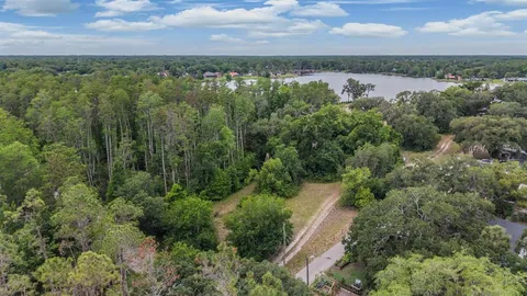 an aerial view of a houses with outdoor space and trees