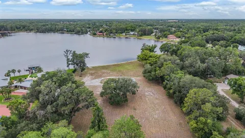 an aerial view of a houses with a lake view