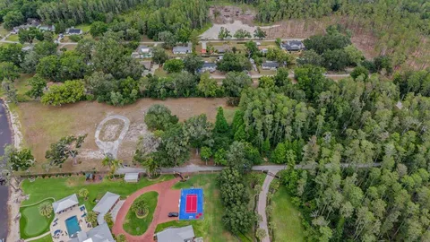 an aerial view of residential house with outdoor space and swimming pool