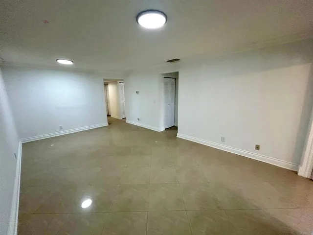 an empty room with a projector and a window