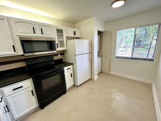 a kitchen with a stove microwave and refrigerator