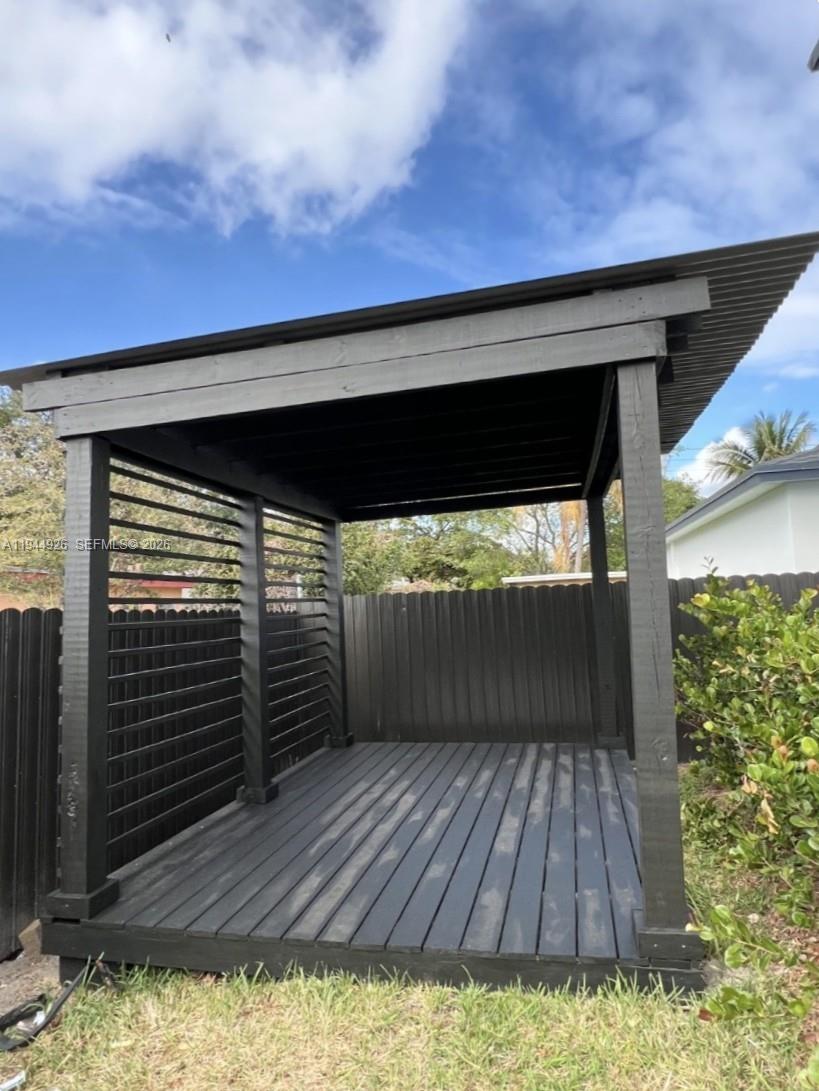 8012 Northwest 14th Place, Unit A Miami, FL 33147 - Photo 12 of 12 a backyard of a house with wooden floor