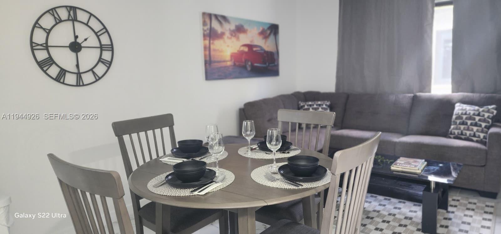 8012 Northwest 14th Place, Unit A Miami, FL 33147 - Photo 3 of 12 a view of a dining room with furniture a rug and wooden floor