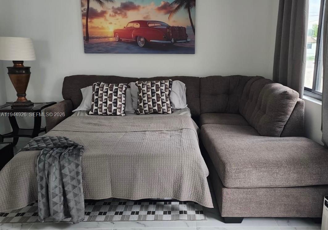 8012 Northwest 14th Place, Unit A Miami, FL 33147 - Photo 6 of 12 a living room with furniture and a window