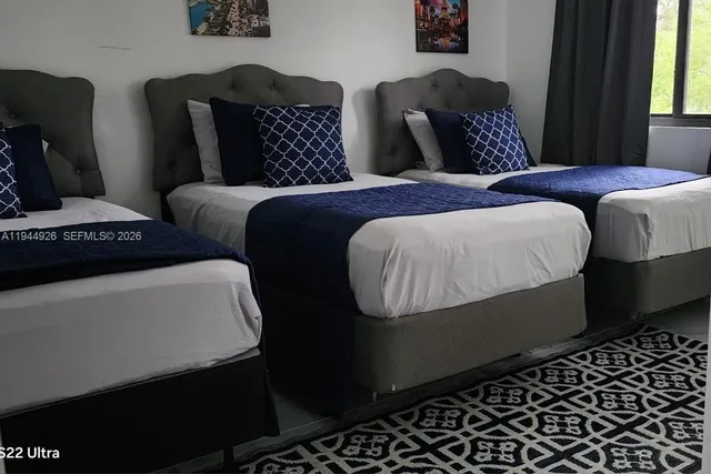 a bedroom with bed and window