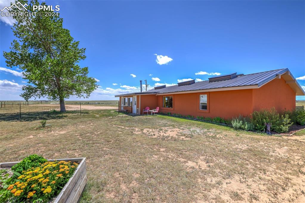 6910 Sengbeil Road Yoder, CO 80864 - Photo 3 of 50 a front view of a house with a yard