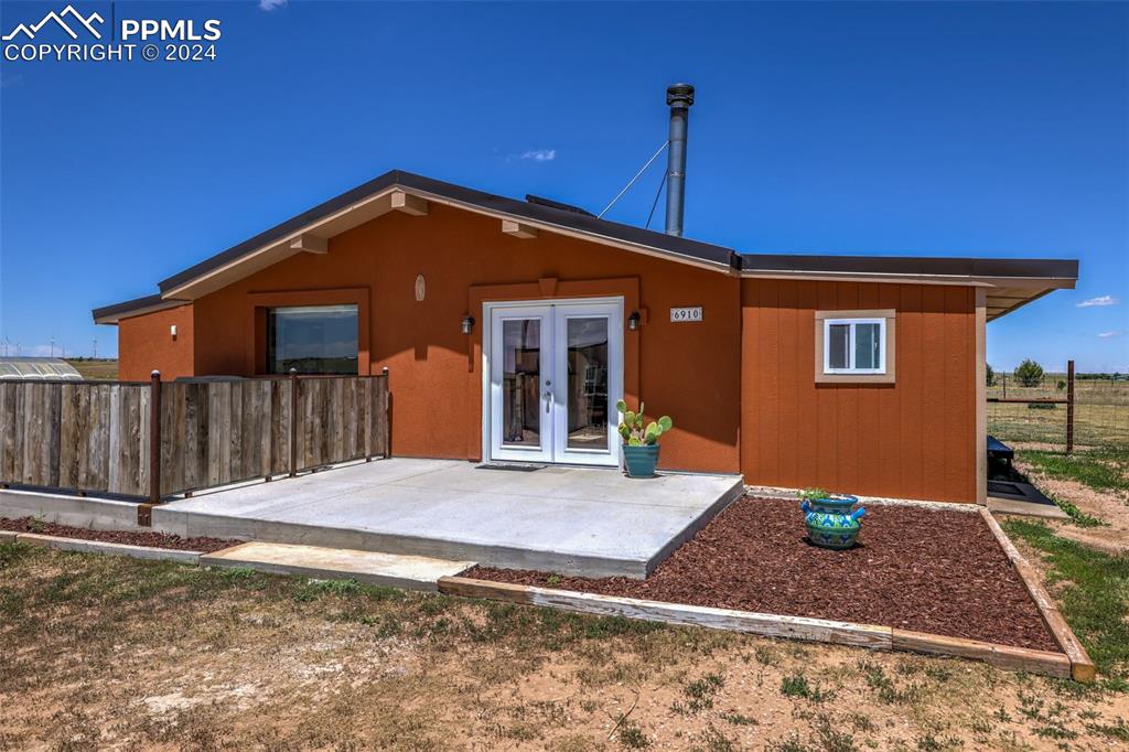 6910 Sengbeil Road Yoder, CO 80864 - Photo 4 of 50 a front view of a house with a yard