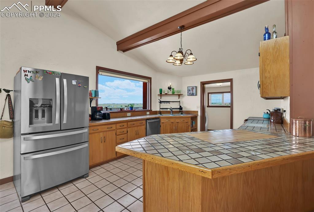 6910 Sengbeil Road Yoder, CO 80864 - Photo 8 of 50 a kitchen with stainless steel appliances granite countertop a sink stove and refrigerator