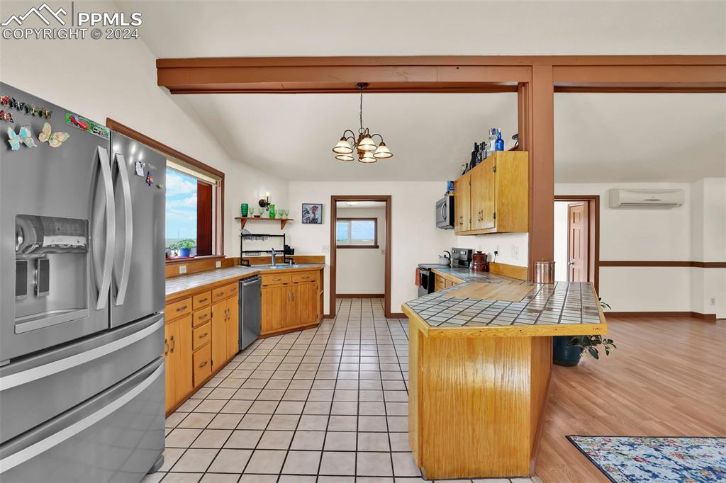 6910 Sengbeil Road Yoder, CO 80864 - Photo 9 of 50 a kitchen with stainless steel appliances granite countertop a sink and a refrigerator