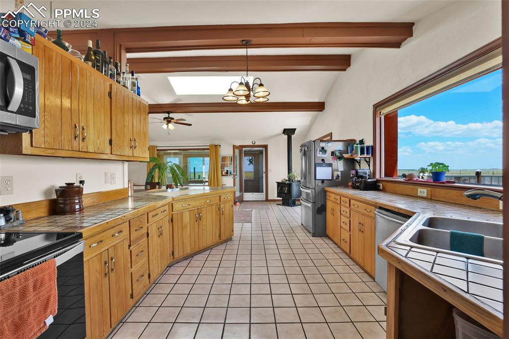 6910 Sengbeil Road Yoder, CO 80864 - Photo 10 of 50 a kitchen with a sink stove and cabinets