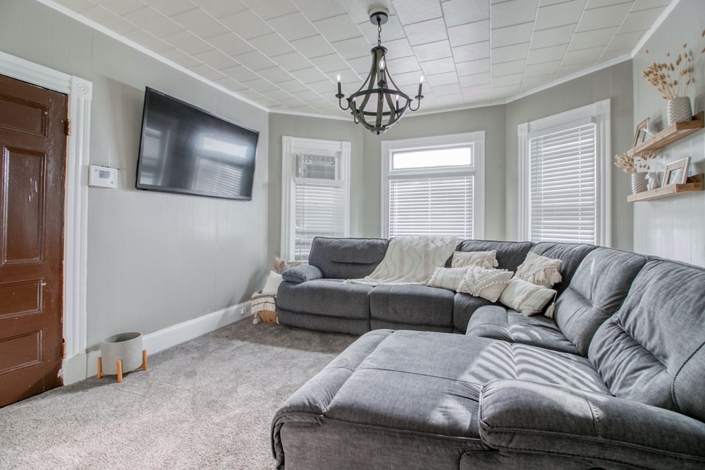 28 Rutledge Avenue Springfield, MA 01105 - Photo 14 of 22 a living room with furniture and a chandelier