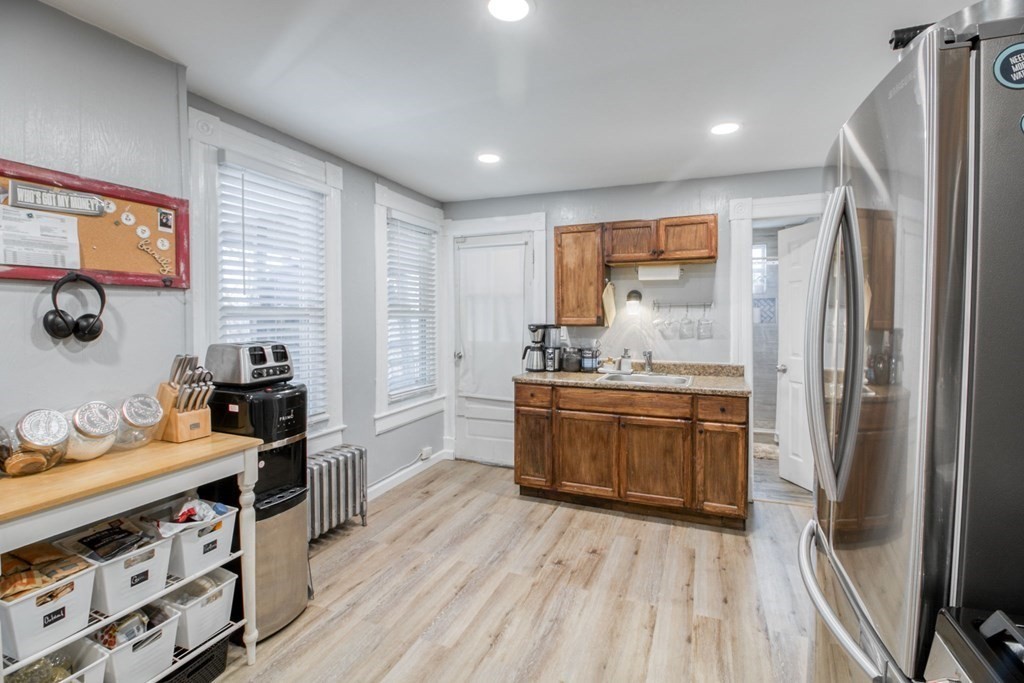 28 Rutledge Avenue Springfield, MA 01105 - Photo 7 of 22 a kitchen with stainless steel appliances kitchen island granite countertop a refrigerator stove and sink