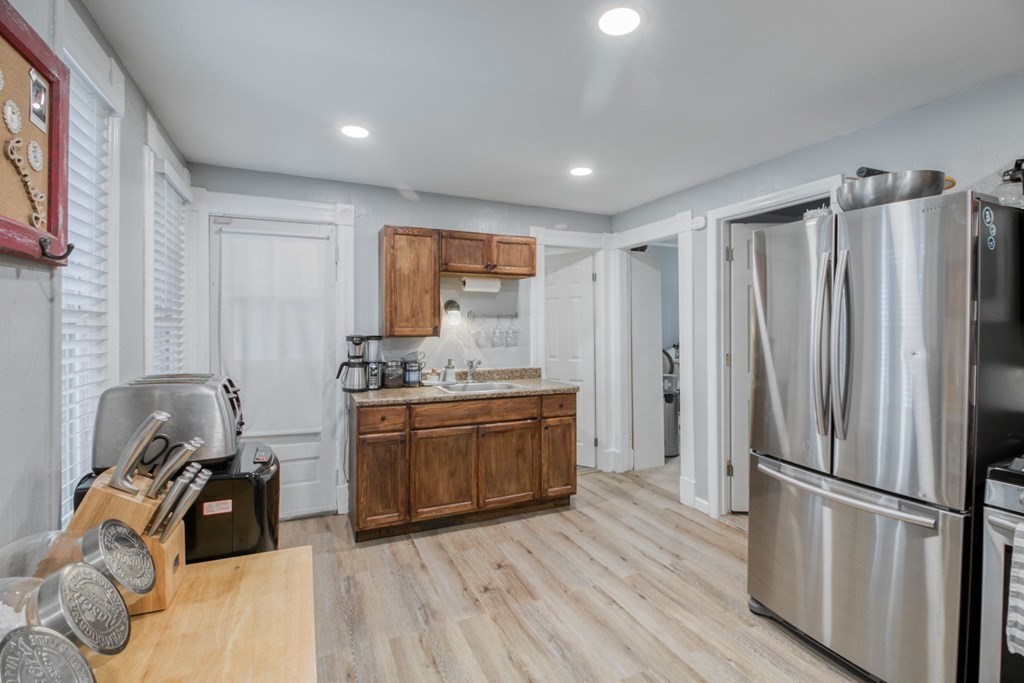 28 Rutledge Avenue Springfield, MA 01105 - Photo 8 of 22 a kitchen with stainless steel appliances granite countertop a refrigerator a stove a sink dishwasher and a refrigerator with wooden floor