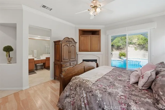 a bedroom with a large bed and a chandelier