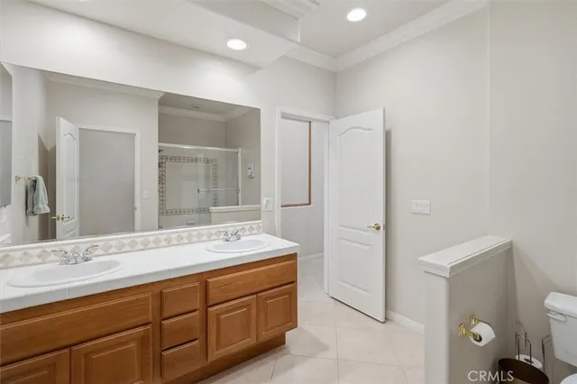 a spacious bathroom with a double vanity sink and mirror
