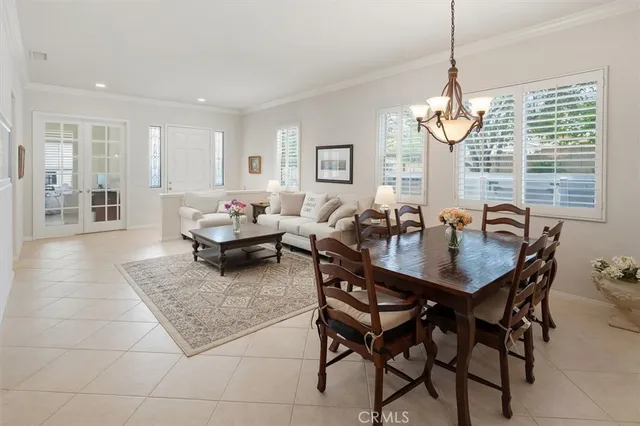 a living room with fireplace furniture and a chandelier