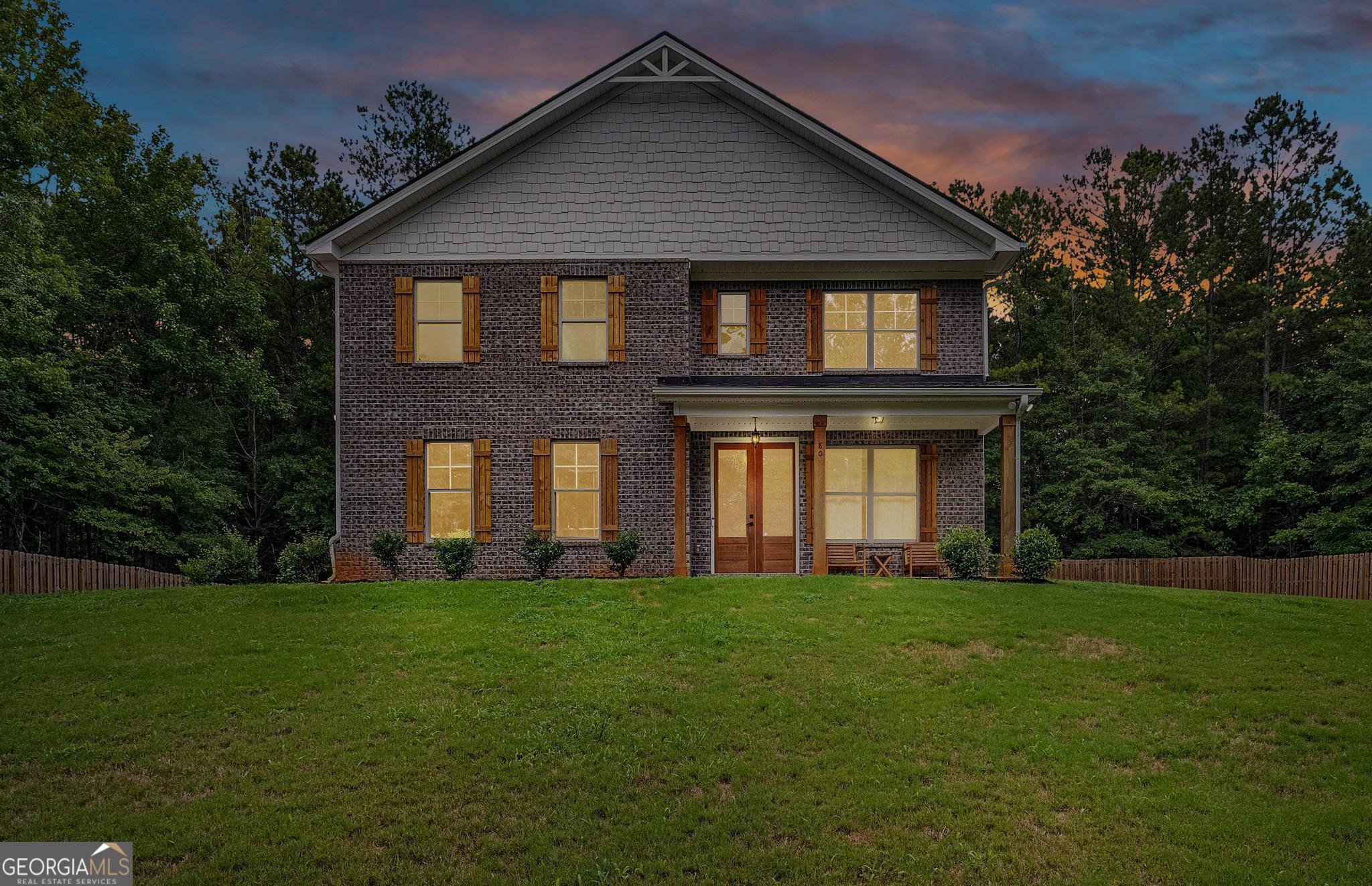 a front view of a house with a yard