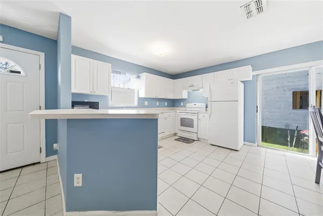 a kitchen with stainless steel appliances a refrigerator sink and cabinets