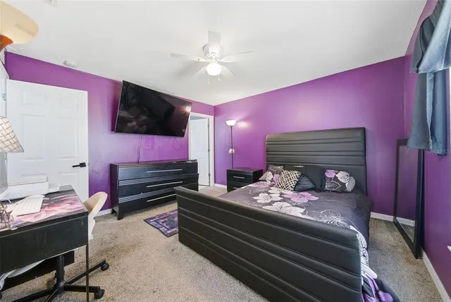 a bed room with furniture and a flat screen tv