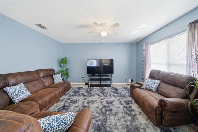 a living room with furniture and a window