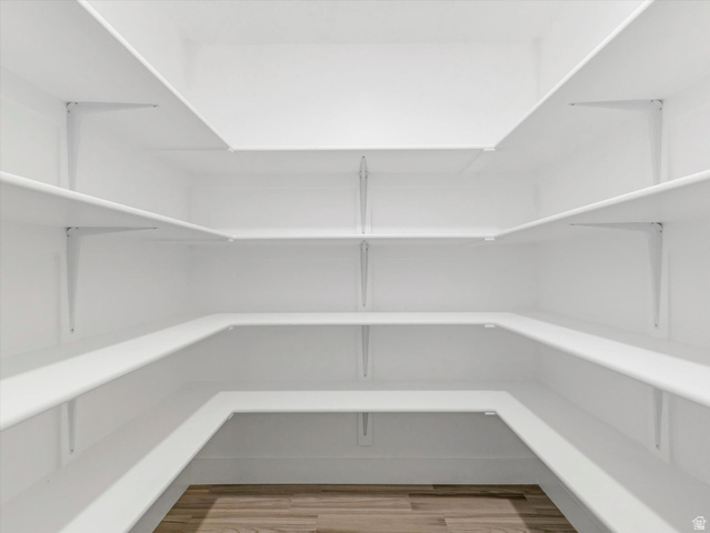 1278 South Grace Way Layton, UT 84041 - Photo 5 of 23 Walk-in pantry featuring expansive shelving, white walls, and wood-finish flooring