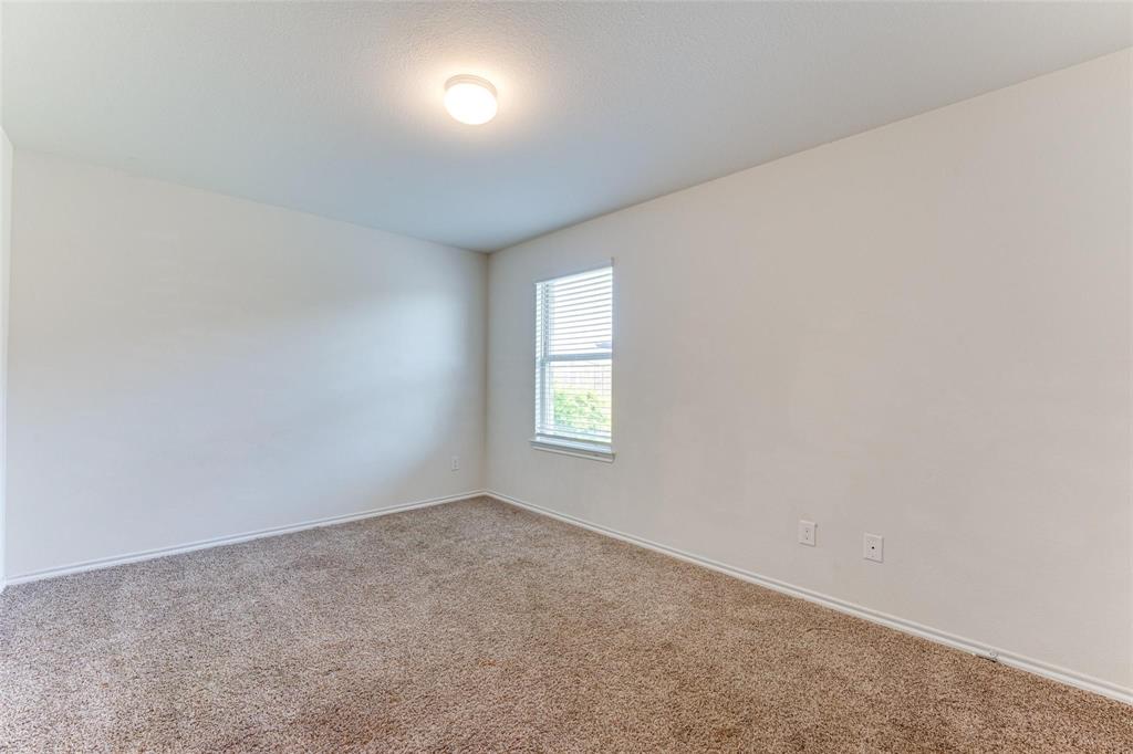 517 Milo Way Royse City, TX 75189 - Photo 20 of 34 Bright room featuring neutral-toned carpet, a single window with blinds, and a flush-mount ceiling light fixture