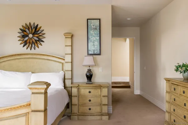 a bedroom with a bed and a chandelier