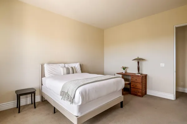 a bedroom with a bed and a chair