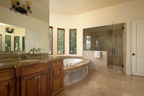 a bathroom with a granite countertop sink mirror and bathtub